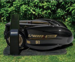 How does the robotic lawn mower charge itself?